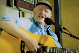 Tom O'Donnell playing a guitar